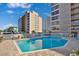 Outdoor pool with lounge chairs surrounded by condos provides a relaxing experience at Ocean View Tower at 7601 N Ocean Blvd. # 3-B, Myrtle Beach, SC 29572