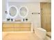 Modern bathroom with double vanity, floating cabinets, and backlit circular mirrors at 7610 Driftwood Dr., Myrtle Beach, SC 29572