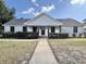 Charming one-story home with white brick, dark accents, and a well-maintained front yard at 7610 Driftwood Dr., Myrtle Beach, SC 29572