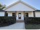 Inviting home facade featuring brick-supported porch, crisp white trim, and well-manicured landscaping at 7610 Driftwood Dr., Myrtle Beach, SC 29572