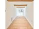 Hallway with wood floors and decorative ceiling beams leading to the sliding door and deck at 7610 Driftwood Dr., Myrtle Beach, SC 29572