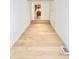 Hallway boasting hardwood floors, with a view to the kitchen and a bedroom at 7610 Driftwood Dr., Myrtle Beach, SC 29572