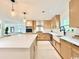 Spacious kitchen with large island, stainless appliances, light wood cabinets, and modern fixtures at 7610 Driftwood Dr., Myrtle Beach, SC 29572