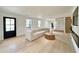Bright living room featuring hardwood floors, large windows, and an open layout with modern decor at 7610 Driftwood Dr., Myrtle Beach, SC 29572