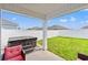 Relaxing backyard patio featuring a hot tub, green grass, and a white privacy fence at 821 Twickenham Loop, Longs, SC 29568