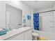 Bright bathroom showcasing sink with generous vanity space, a shower and decorated wall at 821 Twickenham Loop, Longs, SC 29568