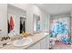 Bright bathroom featuring double sinks, a shower with decorative curtains, and ample space at 821 Twickenham Loop, Longs, SC 29568