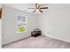 This carpeted bedroom has a large window that provides ample natural light at 821 Twickenham Loop, Longs, SC 29568