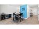Dining area with a modern table set and decor, adjacent to a living space at 821 Twickenham Loop, Longs, SC 29568