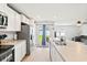 Modern kitchen with stainless steel appliances and countertop overlooking the living room at 821 Twickenham Loop, Longs, SC 29568
