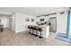 Spacious kitchen island with seating, stainless appliances, and wood-look flooring at 821 Twickenham Loop, Longs, SC 29568