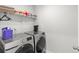 Laundry room with modern washer and dryer units and storage shelves at 821 Twickenham Loop, Longs, SC 29568