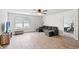 Comfortable living area with a plush sectional, wood-look floors, and natural light at 821 Twickenham Loop, Longs, SC 29568