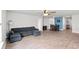 Spacious open-concept living area with wood flooring and comfortable sectional seating at 821 Twickenham Loop, Longs, SC 29568
