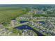 Aerial view showcasing a community with winding streets, lush landscaping, and tranquil ponds at 8708 Coosaw Ct., Myrtle Beach, SC 29577