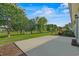 Relaxing backyard featuring a concrete patio, lush lawn, and a scenic pond view with mature trees at 8708 Coosaw Ct., Myrtle Beach, SC 29577