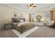 Bedroom with a large bed, neutral carpet, ceiling fan, and windows at 8708 Coosaw Ct., Myrtle Beach, SC 29577