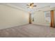 Spacious bedroom with neutral carpet, ceiling fan, and windows at 8708 Coosaw Ct., Myrtle Beach, SC 29577