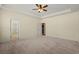 Large carpeted bedroom with a ceiling fan and an open door at 8708 Coosaw Ct., Myrtle Beach, SC 29577
