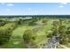 Scenic aerial view of a lush golf course with water features, mature trees, and manicured greens at 8708 Coosaw Ct., Myrtle Beach, SC 29577