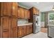 Kitchen featuring light green walls with warm wood cabinetry and stainless steel appliances at 8708 Coosaw Ct., Myrtle Beach, SC 29577