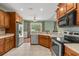 Well-equipped kitchen featuring stainless steel appliances and beautiful wood cabinetry with a view to the dining area at 8708 Coosaw Ct., Myrtle Beach, SC 29577