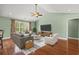 Staged living room featuring hardwood floors, comfortable seating, and a modern entertainment setup at 8708 Coosaw Ct., Myrtle Beach, SC 29577