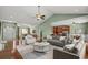 Well-furnished living room highlighting an open-concept design, hardwood floors, and seamless flow to dining area at 8708 Coosaw Ct., Myrtle Beach, SC 29577