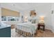 Inviting bedroom with a decorative rug, a window with blinds, and a comfortable bed setup at 901 W Port Dr. # 2114, North Myrtle Beach, SC 29582