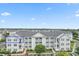 Exterior view of condo building featuring a white facade, balconies and neatly landscaped surroundings at 901 W Port Dr. # 2114, North Myrtle Beach, SC 29582