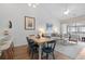 Open-concept living and dining area with a dining table and comfortable seating by a balcony at 901 W Port Dr. # 2114, North Myrtle Beach, SC 29582