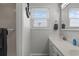 Bright bathroom with double sinks, white cabinets, and an anchor decoration at 920 N Waccamaw Dr. # 2310, Murrells Inlet, SC 29576