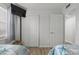Bright bedroom with closet and flat screen television at 920 N Waccamaw Dr. # 2310, Murrells Inlet, SC 29576