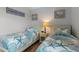 Bedroom with coastal decor, featuring two twin beds, and side table at 920 N Waccamaw Dr. # 2310, Murrells Inlet, SC 29576