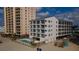 Beachside condo building exterior featuring private balconies and a refreshing pool at 920 N Waccamaw Dr. # 2310, Murrells Inlet, SC 29576