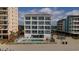 Oceanfront condo building featuring multiple balconies and a shared pool at 920 N Waccamaw Dr. # 2310, Murrells Inlet, SC 29576