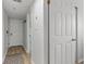 Bright hallway with wood-look floors leads to a white front door and bedrooms at 920 N Waccamaw Dr. # 2310, Murrells Inlet, SC 29576