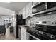 Modern kitchen with stainless steel appliances and a view into the living area at 920 N Waccamaw Dr. # 2310, Murrells Inlet, SC 29576