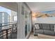 Comfortable living room with balcony access, featuring a cozy sofa and a picturesque ocean view at 920 N Waccamaw Dr. # 2310, Murrells Inlet, SC 29576