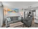 Inviting living room featuring a cozy sofa, coastal decor, and an open layout to the kitchen at 920 N Waccamaw Dr. # 2310, Murrells Inlet, SC 29576