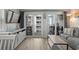 Cozy living room with a gray couch and balcony access featuring ocean views and light wood flooring at 920 N Waccamaw Dr. # 2310, Murrells Inlet, SC 29576