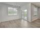 Bright dining area features hardwood floors, modern chandelier, and sliding glass doors to the patio at 964 Irving Dr., Little River, SC 29566