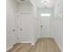 Bright foyer with paneled walls, wood-look floors, and white doors at 964 Irving Dr., Little River, SC 29566