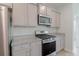 Modern kitchen with stainless steel appliances, granite countertops and gray shaker style cabinets at 964 Irving Dr., Little River, SC 29566