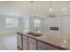 Open kitchen featuring a granite island with a stainless steel double sink, light fixtures and open layout at 964 Irving Dr., Little River, SC 29566