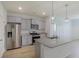 Modern kitchen with stainless steel appliances, gray cabinets, and a large granite island at 964 Irving Dr., Little River, SC 29566