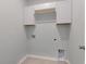 Laundry room featuring overhead cabinets and tile floors at 964 Irving Dr., Little River, SC 29566