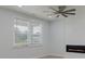 Bright living room features a large window, ceiling fan, and modern fireplace at 964 Irving Dr., Little River, SC 29566