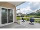 Covered screened patio includes furniture, with views of the backyard and pond at 964 Irving Dr., Little River, SC 29566