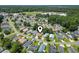 An aerial view showcasing the neighborhood with tree-lined streets and well-maintained homes, with central property highlighted at 1007 Autumn Dr., Murrells Inlet, SC 29576
